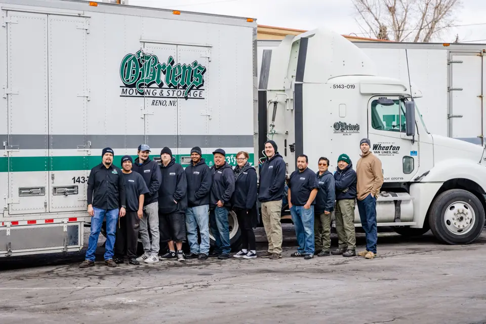 The O'Brien's crew standing together in front of an O'Brien's Moving & Storage truck
