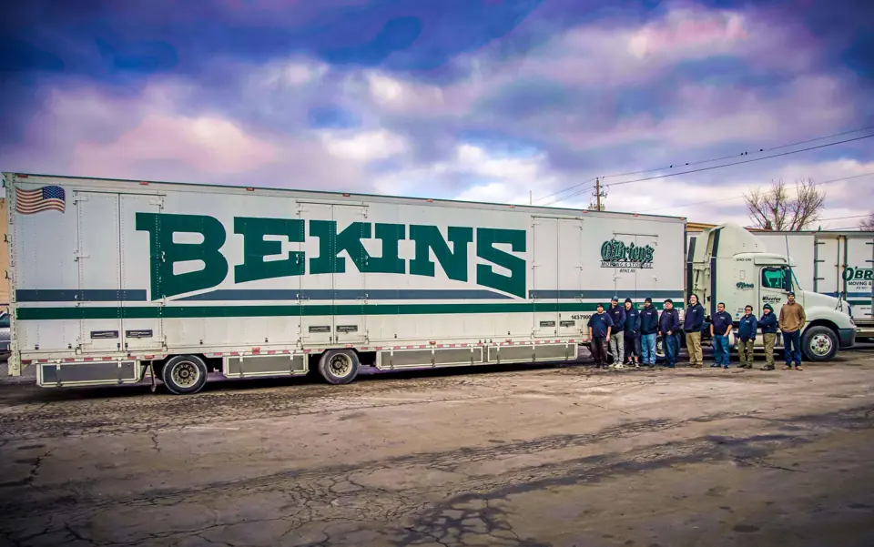 The O'Brien's crew lined up beside a Bekins-liveried tractor-trailer
