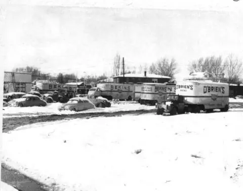 O'Brien's and Bekins trucks in a snowy yard in the 1950s