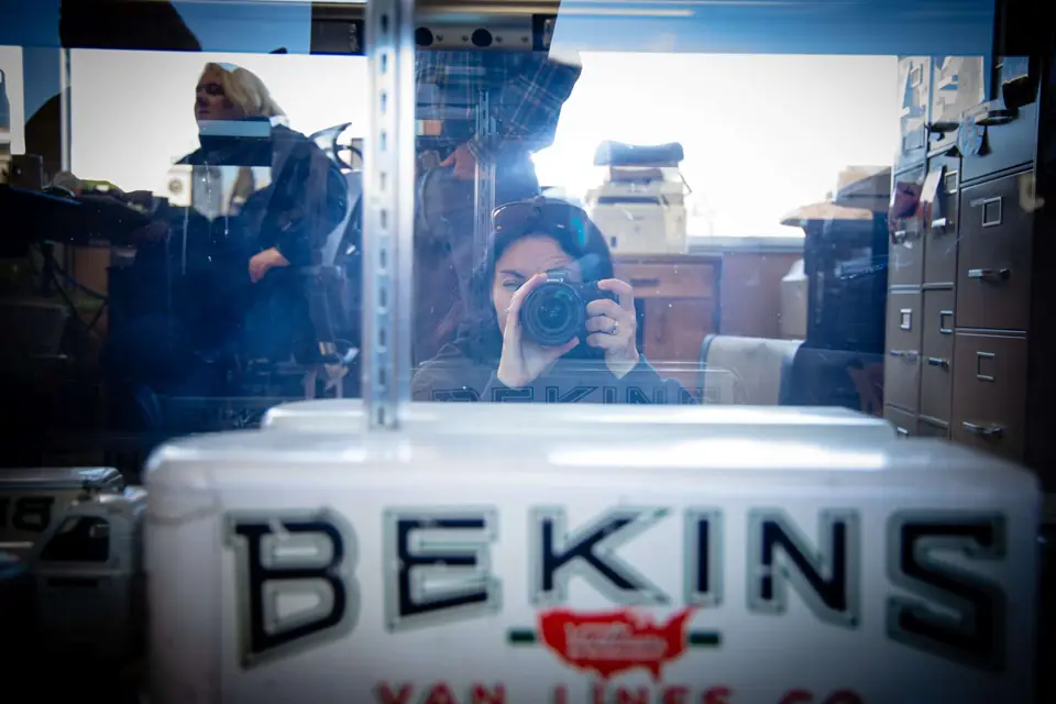 A vintage Bekins Van Lines toy moving van in a display case