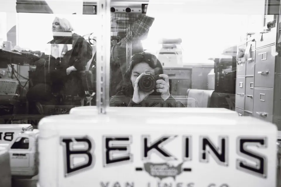 A vintage Bekins Van Lines toy moving van in a display case