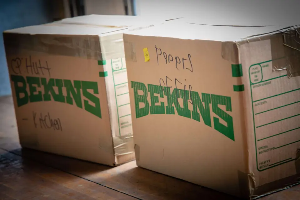 Bekins cartons hand-labelled by room, ready for a move