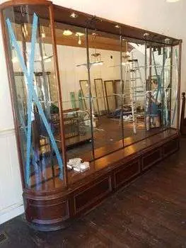 A large antique glass display cabinet after placement