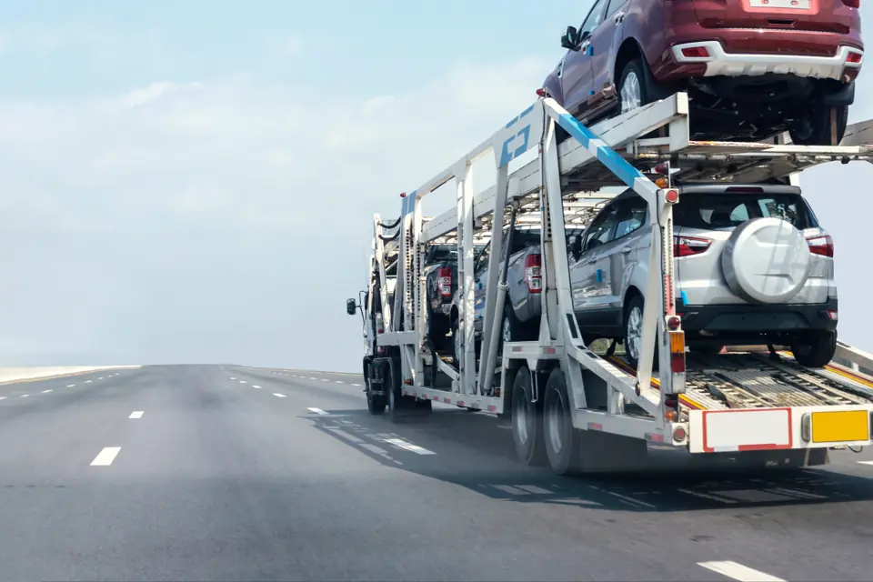 Car-carrier truck loaded with vehicles driving on a highway