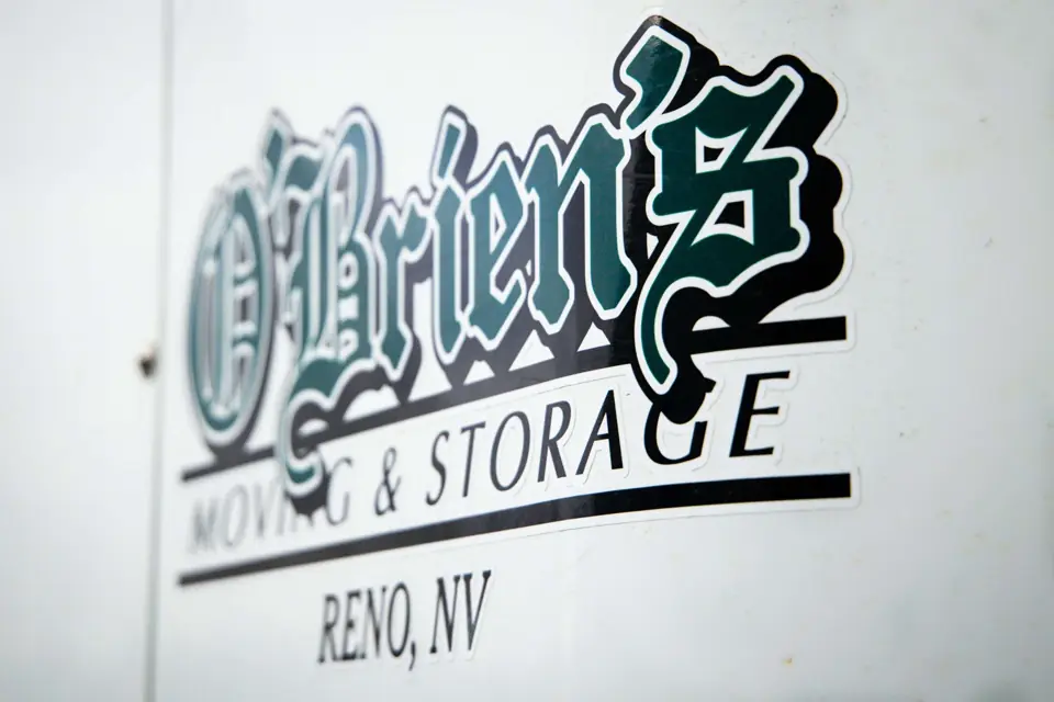 The blackletter O'Brien's Moving & Storage logo on the side of a truck