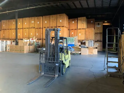 Wooden storage vaults and a forklift inside the O'Brien's warehouse
